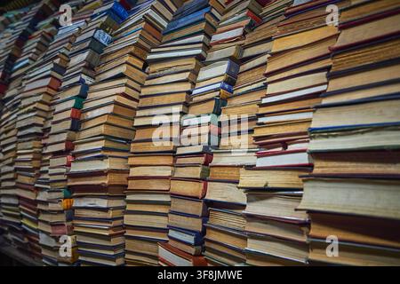 Stacks of Vintage Books Forming a Wall in a Cozy California Bookstore Stock Photo