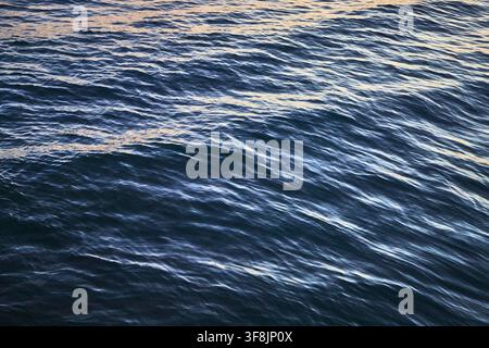 Ocean Surface Close Up with Sunlight Reflections and Gentle Waves Stock Photo