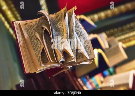 Open Book Art Installation with Curled Pages in Vibrant Los Angeles Bookstore Stock Photo