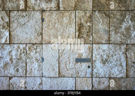 Stone Wall Detail with Mechanical Room Access and Modern Architectural Texture Stock Photo