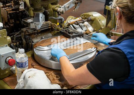 Tampa, FL, USA. 12th Aug 2026. An operator positions strips of tobacco wrapper leaf on the suction plate of an antique cigar-making machine - one dating to the 1930s and still in daily use - in the machine-rolling area of J.C. Newman Cigar Co.'s El Reloj factory in Ybor City. Founded in 1895, fourth-generation J.C. Newman is America's oldest family-owned premium cigar maker, and the 1910 clock-tower building, part of a National Historic Landmark District, is the last operating historic cigar factory in the US. Credit: Tosh Persons / Ģ����ý Live News Stock Photo