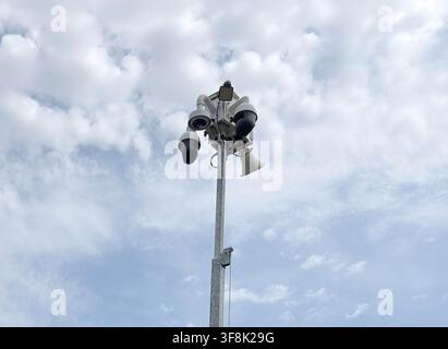 Solar powered mobile security camera trailer with dome cameras, megaphones, solar panels operating in commercial parking lot for crime deterrence Stock Photo