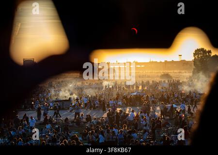 Berlin, Germany. 12th Aug, 2026. Partial solar eclipse of August 12, 2026 viewed through solar eclipse glasses on Tempelhofer Feld in Berlin, Germany, with the Moon obscuring about 85 percent of the Sun. Credit: Oleksandr Prykhodko/Ģ����ý Live News Stock Photo