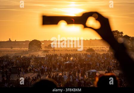 Berlin, Germany. 12th Aug, 2026. Partial solar eclipse of August 12, 2026 viewed through solar eclipse glasses on Tempelhofer Feld in Berlin, Germany, with the Moon obscuring about 85 percent of the Sun. Credit: Oleksandr Prykhodko/Ģ����ý Live News Stock Photo