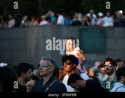 Paris, France. 12th Aug, 2026. A girl wearing solar eclipse glasses observes a partial solar eclipse in Paris, France, Aug. 12, 2026. Credit: Wu Huiwo/Xinhua/Alamy Live News Stock Photo