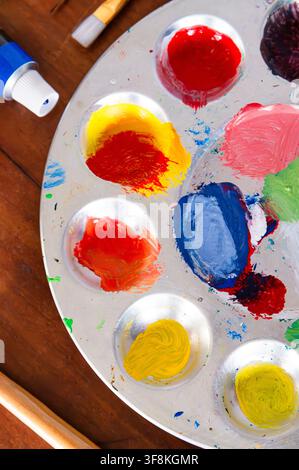 Close up of a paint palette with artist paint, brushes and tube of paint Stock Photo