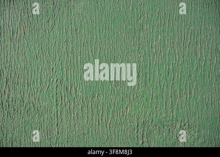 Green textured surface with vertical wrinkles resembling leather or fabric pattern. Stock Photo