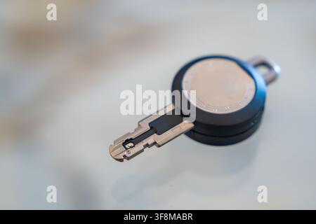 Close up of an RFID key fob with a visible electronic contact chip on a white background. Concept of electronic authentication, secure access and Stock Photo