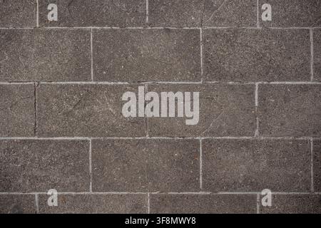 Top view of grey rectangular paving stones forming a textured brick pattern. Stock Photo