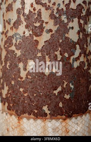 Heavily rusted metal surface with peeling paint and corrosion texture. Stock Photo