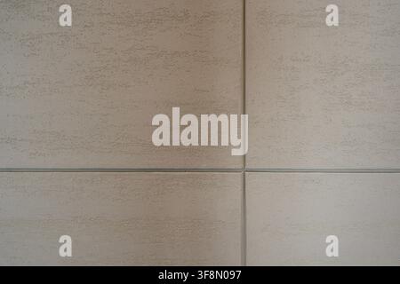 Light beige textured plaster wall surface background with grid lines. Stock Photo