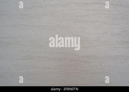 Light grey textured plaster wall surface background with horizontal brush strokes. Stock Photo