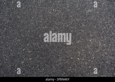Black PVC coil mat texture with scattered dirt and debris background. Stock Photo