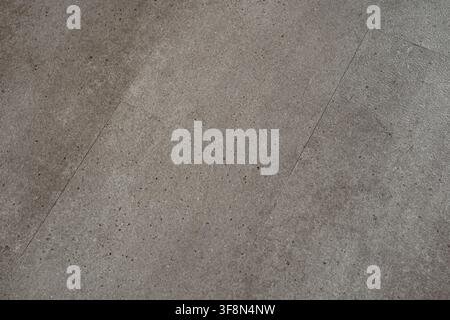 Gray stone floor tile texture with speckled surface and visible joints. Stock Photo