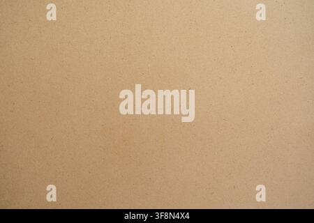 Brown MDF board texture background. Close up of smooth cardboard or craft paper surface. Stock Photo