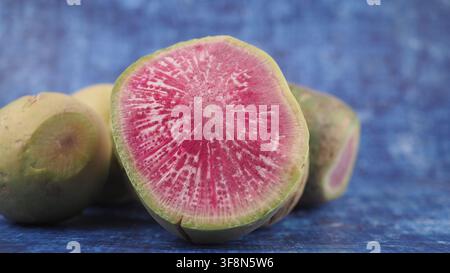Fresh half of watermelon radish on a blue background Stock Photo