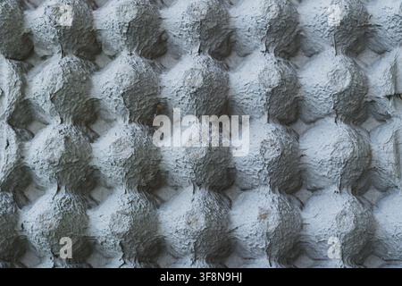 Full frame flat lay overhead view of empty molded paper pulp egg carton showing repeating geometric texture pattern. Stock Photo