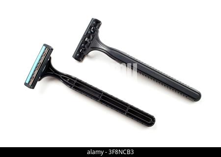 Two disposable plastic razors on a white background. Black disposable razors. Stock Photo