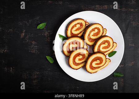 Traditional Swiss Roll with Apricot Filling and Fresh Apricots. Top view Stock Photo