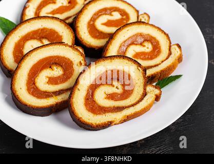 Sweet Apricot Swiss Roll Dessert on Dark Background Stock Photo