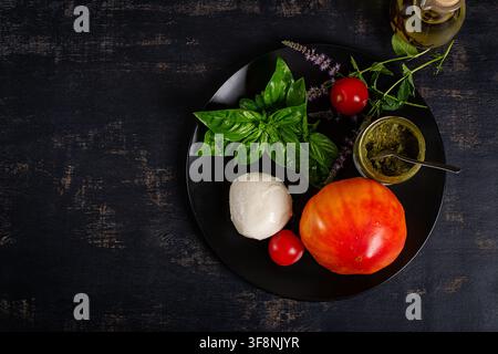 Fresh Caprese Ingredients with Mozzarella, Tomato and Basil. Top view Stock Photo