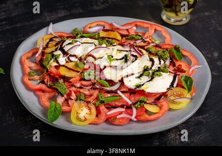 Fresh Italian Caprese Salad with Basil and Pesto Dressing Stock Photo