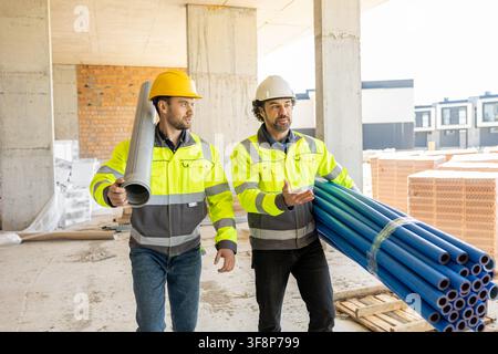 Two professional engineers walking and discussing project Stock Photo