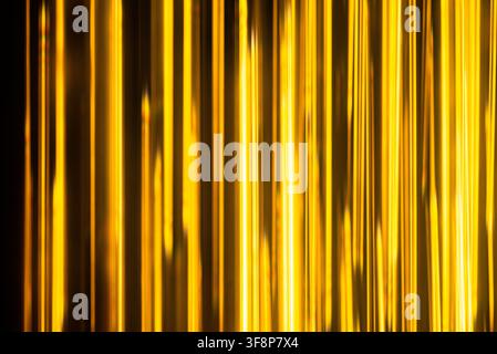 Clean geometric pattern of bright golden neon bars glowing smoothly on a dark backdrop texture Stock Photo