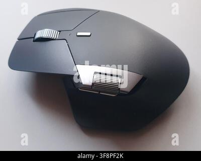 A closeup view of a modern dark grey computer mouse Stock Photo