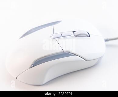 A modern white computer mouse sits on a clean white background Stock Photo