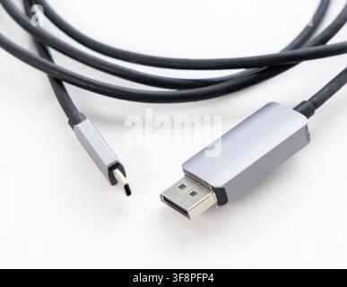 A black USBC to DisplayPort cable rests on a white background Stock Photo