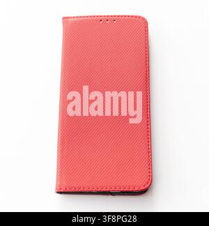 A vibrant red textured smartphone case lies on a white background Stock Photo
