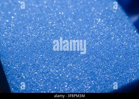 A sparkling blue foam texture with glittery surface and soft bokeh lighting Stock Photo