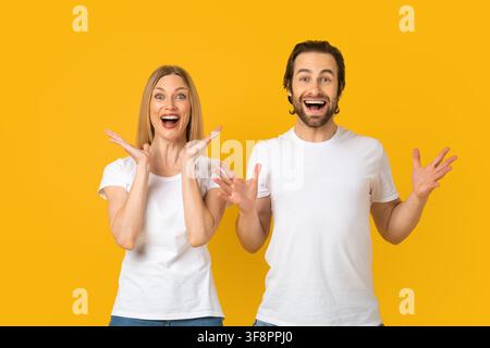 Happy Young Couple Smiling And Celebrating Together, Joyful Emotion, Studio Setting Stock Photo