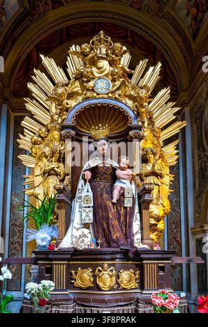 Crowned statue of Our Lady of Mount Carmel with the Christ Child holding the scapular in Santa Maria in Traspontina. Rome, Italy. Stock Photo