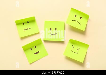 Sticky notes with drawings of different emotion faces on beige background Stock Photo