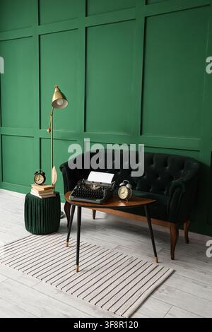 Interior of stylish living room with sofa and vintage typewriter on table Stock Photo