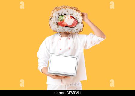 Chef with sushi roll head holding a laptop with blank screen, food service technology and culinary innovation Stock Photo