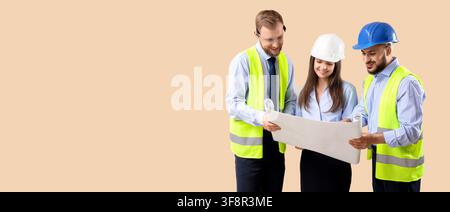 Three diverse construction workers in hard hats and safety vests reviewing blueprints, engineering and architecture team collaboration Stock Photo
