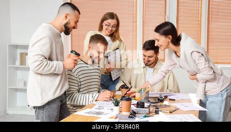 Creative team of graphic designers collaborating on calligraphy and lettering projects in a modern office, Several young adults are engaged in drawing Stock Photo