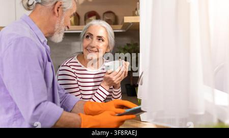 Happy Senior Couple Cooking Together In Kitchen, Woman Enjoying Cooking Experience Stock Photo
