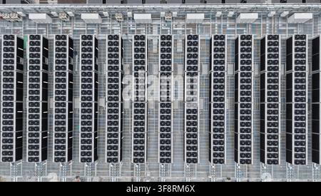 Modern data center and server farm showing rows of cooling units with fans, part of vast digital storage and networking infrastructure Stock Photo