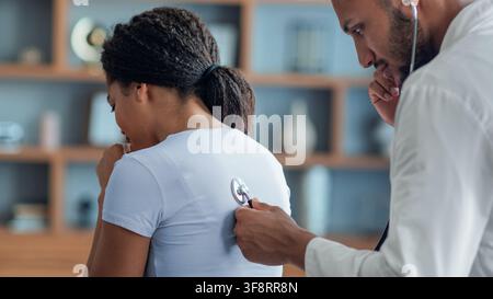 Doctor Examining Black Woman With Stethoscope In Clinic, Healthcare Concept Stock Photo