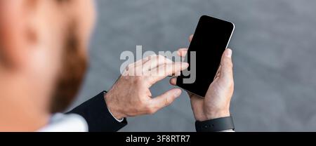 Unrecognizable Person Using Smartphone At Office, Engaged In Digital Communication Stock Photo