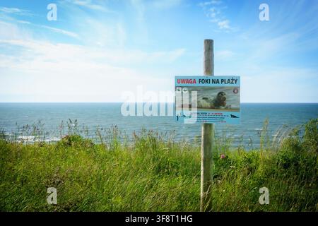 The unspoilt coastline of Jastrzębia Góra in the north of Poland on the Baltic sea. The sign reads Warning Seals on the Beach Stock Photo