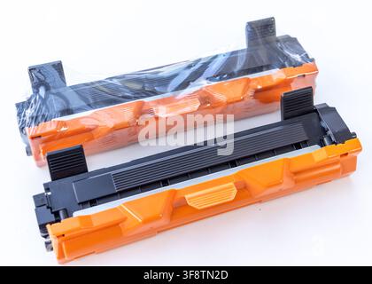 Two new black and orange printer toner cartridges are on white Stock Photo