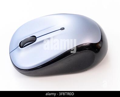 A sleek wireless computer mouse sits on a clean white background Stock Photo