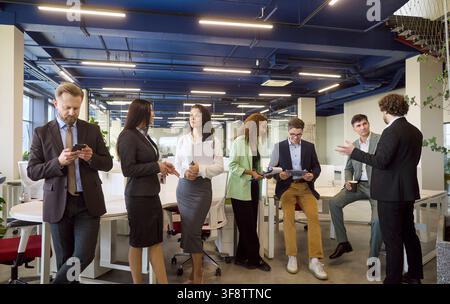 Diverse professionals networking and collaborating in a bright modern office Stock Photo