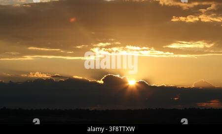 Heavenly Golden Sunrise Breaking Through Storm Clouds Stock Photo