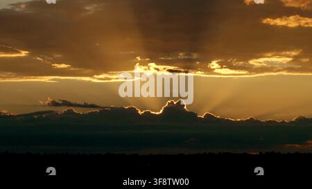 Heavenly Golden Sunrise Breaking Through Storm Clouds Stock Photo